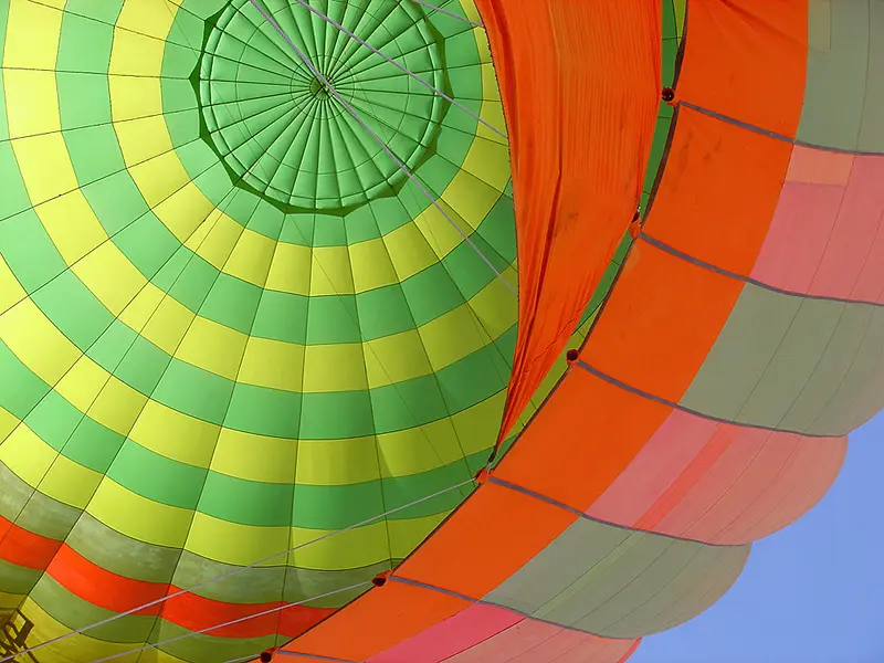 Looking up inside the colorful envelope of a hot air balloon