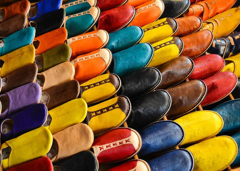 Colorful leather babouche slippers displayed in a Marrakech souk